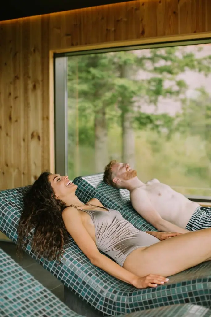Home 18 Young couple relaxing on the tepidarium bed in the